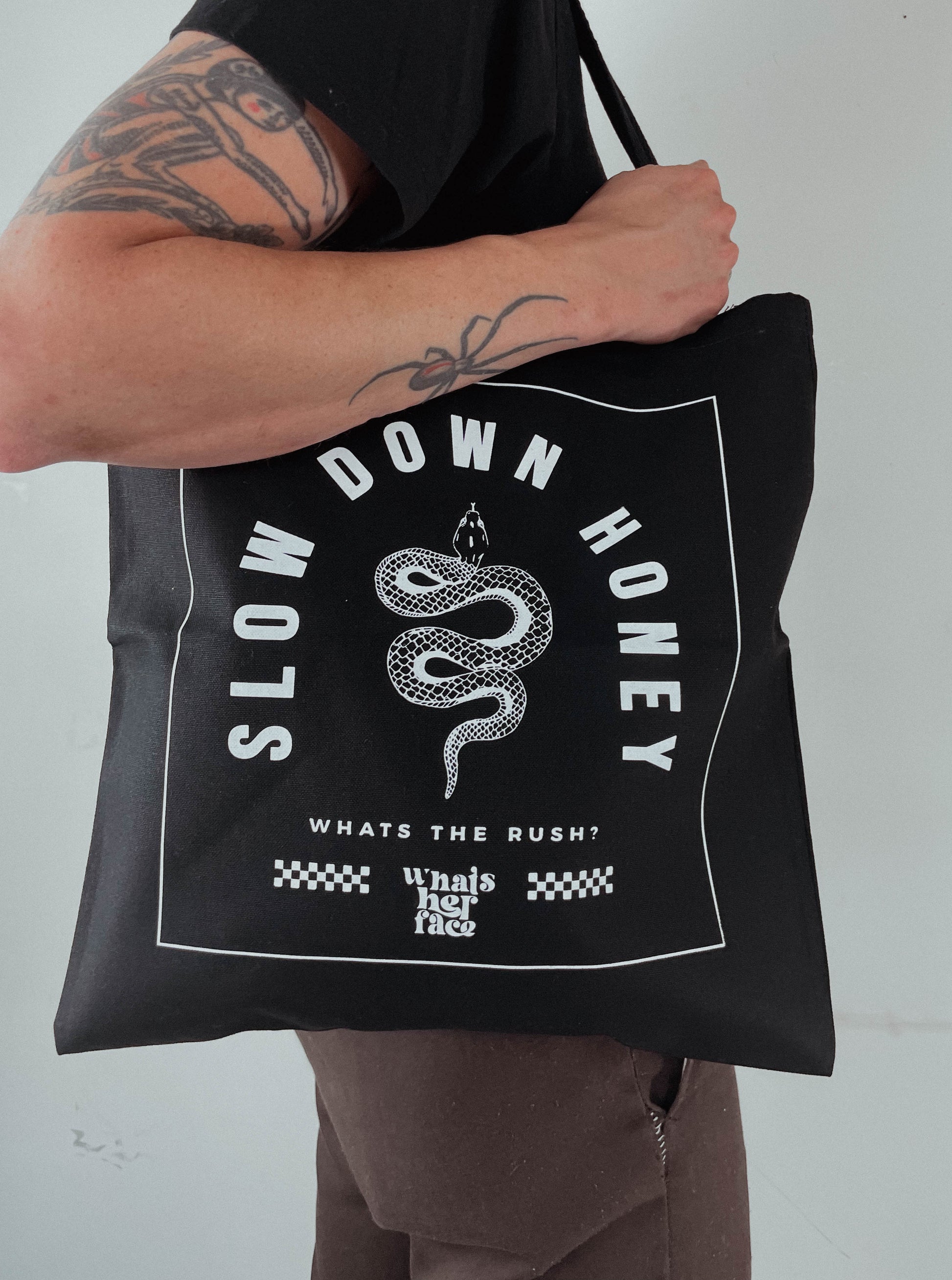 Black tote bag with snake and slow down honey graphic