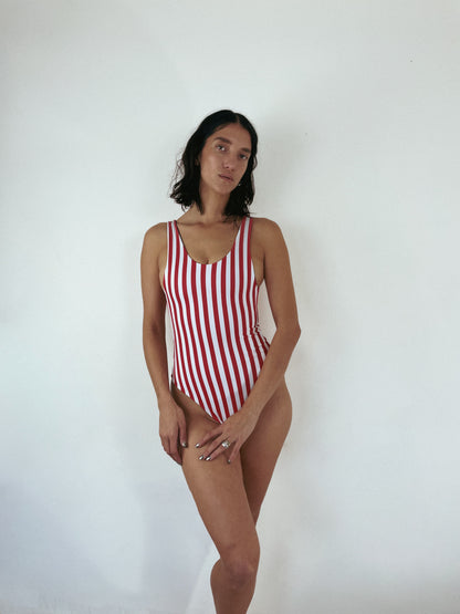 cheeky one piece swimsuit. custom reversible swimwear in red and white stripe